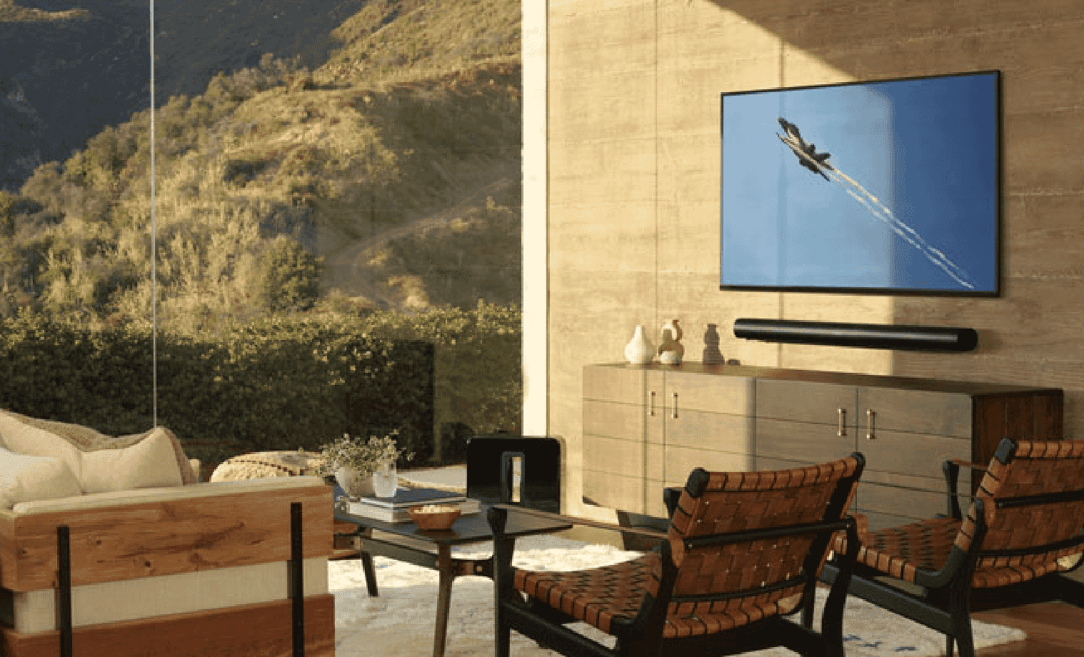 A modern style living room with a large TV and soundbar mounted on the wall