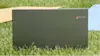 Chromebook sitting in grass outside.