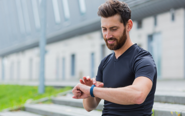 Father checking his fitness watch after a workout
