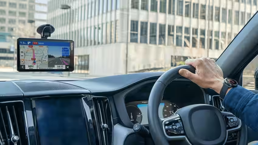 Image of a man driving with a Garmin GPS installed in the car.