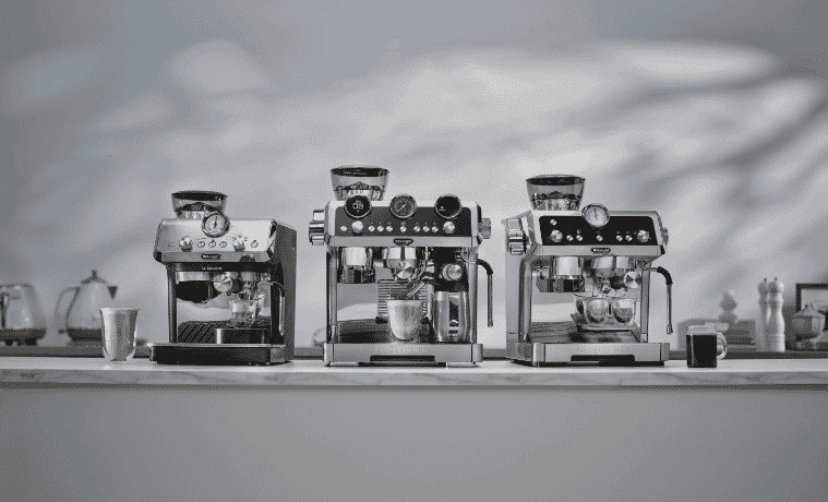 A bench with three shiny new DeLonghi coffee machines available at The Good Guys