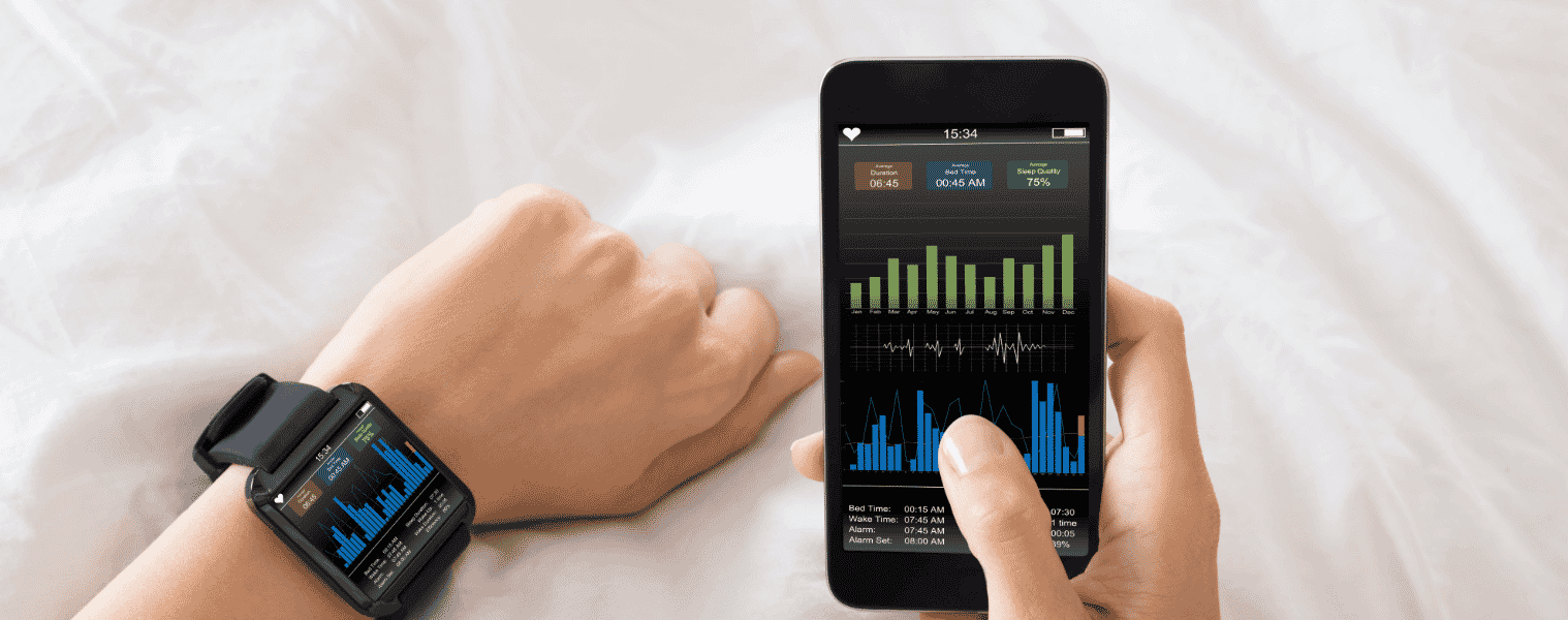 A person tracks their sleep cycle on an app connected to their smartphone and smart watch