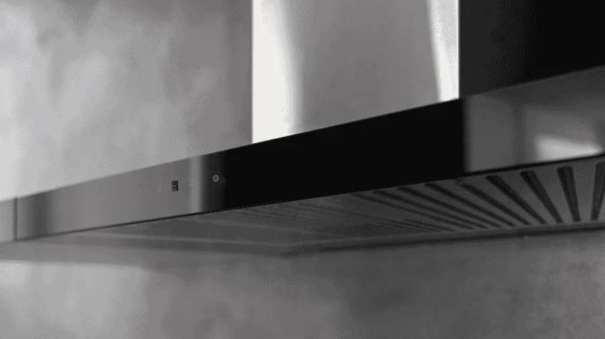 close up of metal Solt rangehood against grey wall