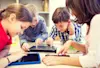 Multiple kids using their tablets in a classroom