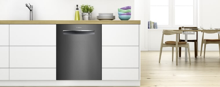 A dark stainless steel dishwasher in a small kitchen