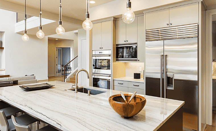 A neutral coloured kitchen with silver appliances