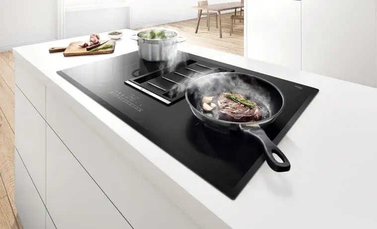 Induction Cooktops cooking food on white countertop