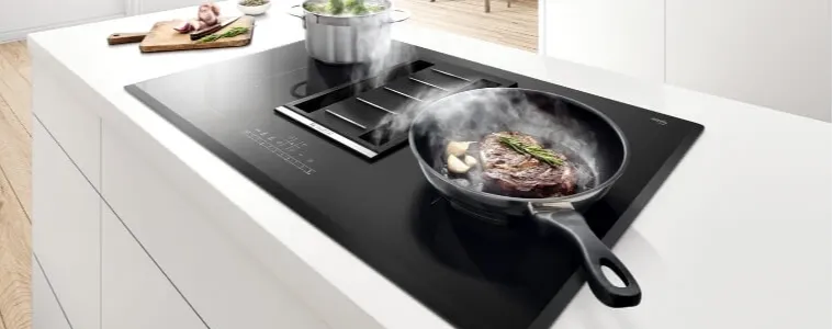 Induction Cooktops cooking food on white countertop 