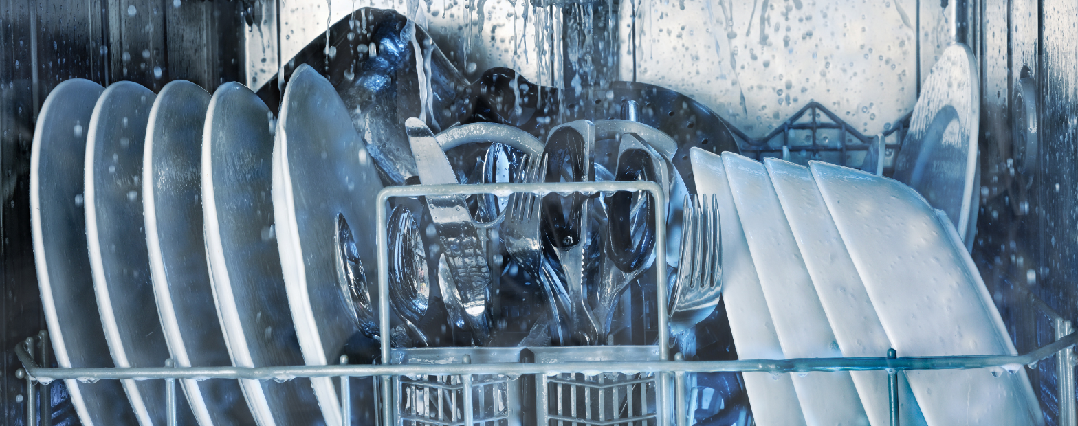 Dishes inside dishwasher being sprayed with water