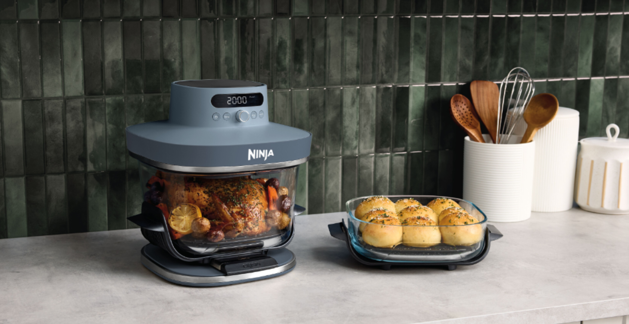 Image of the Ninja Crispi Pro 6-in-1 Countertop Glass Air Fryer Cyberspace in use on a kitchen bench