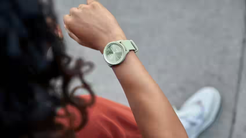 Lifestyle image of a woman looking at her Garmin Smart Watch