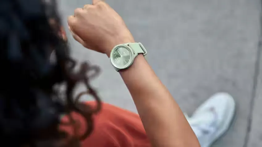 Lifestyle image of a woman looking at her Garmin Smart Watch