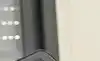 A person viewing controlling their home security via a tablet