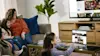 Girl using her Chromebook in family living room. 