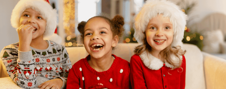 3 girls sitting on the couch watching Christmas movies together 