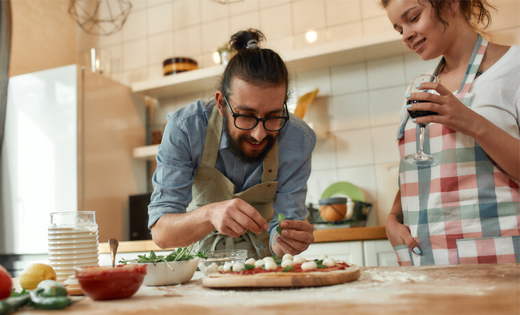 A young couple makes pizza together at home