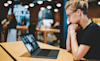 Woman using her Lenovo laptop at a cafe on the go 