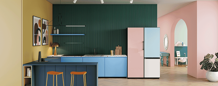 The Samsung Bespoke fridge with white pale pink and light blue front door panels in a colourful kitchen with navy bench and dark green textured back wall 
