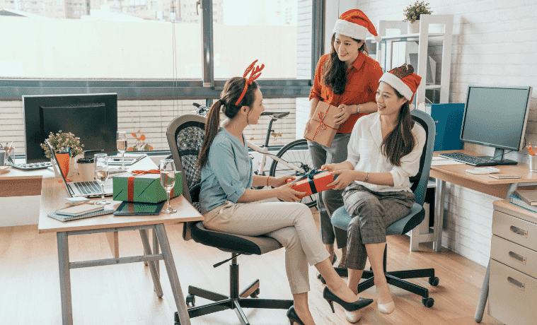 Friends exchanging Secret Santa Christmas Gifts