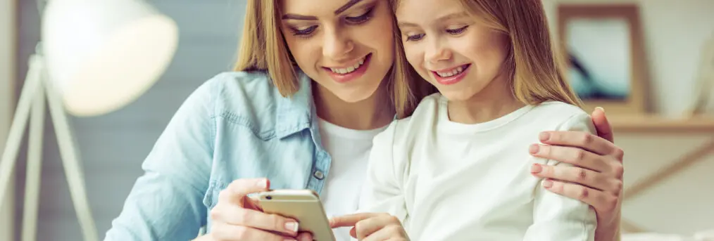 Mother & Daughter Holding a Phone