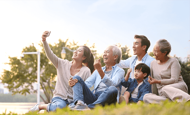 Happy family taking a group photo with their new Mobile Phone from The Good Guys