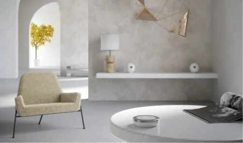 About Devialet Two of the Devialet PHANTOM 1 speakers sit in a monochromatic living room on a floating console table A Devialet PHANTOM remote sits on a coffee table in front