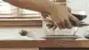 Male stacking dirty plates into an integrated dishwasher.