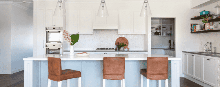 White and blue Hamptonsstyle kitchen with pendant lights