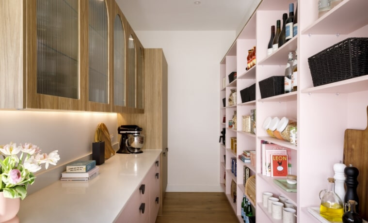 Pink butlers pantry with silver and black stand mixer appliance
