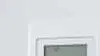 Man pointing remote to air con on the wall.