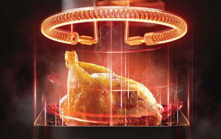 Glowing infrared heating element above a golden roast chicken, showing heat surrounding the food from top to bottom.