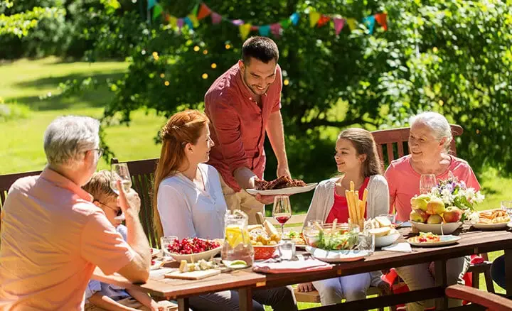 A family enjoying a meal outdoors 