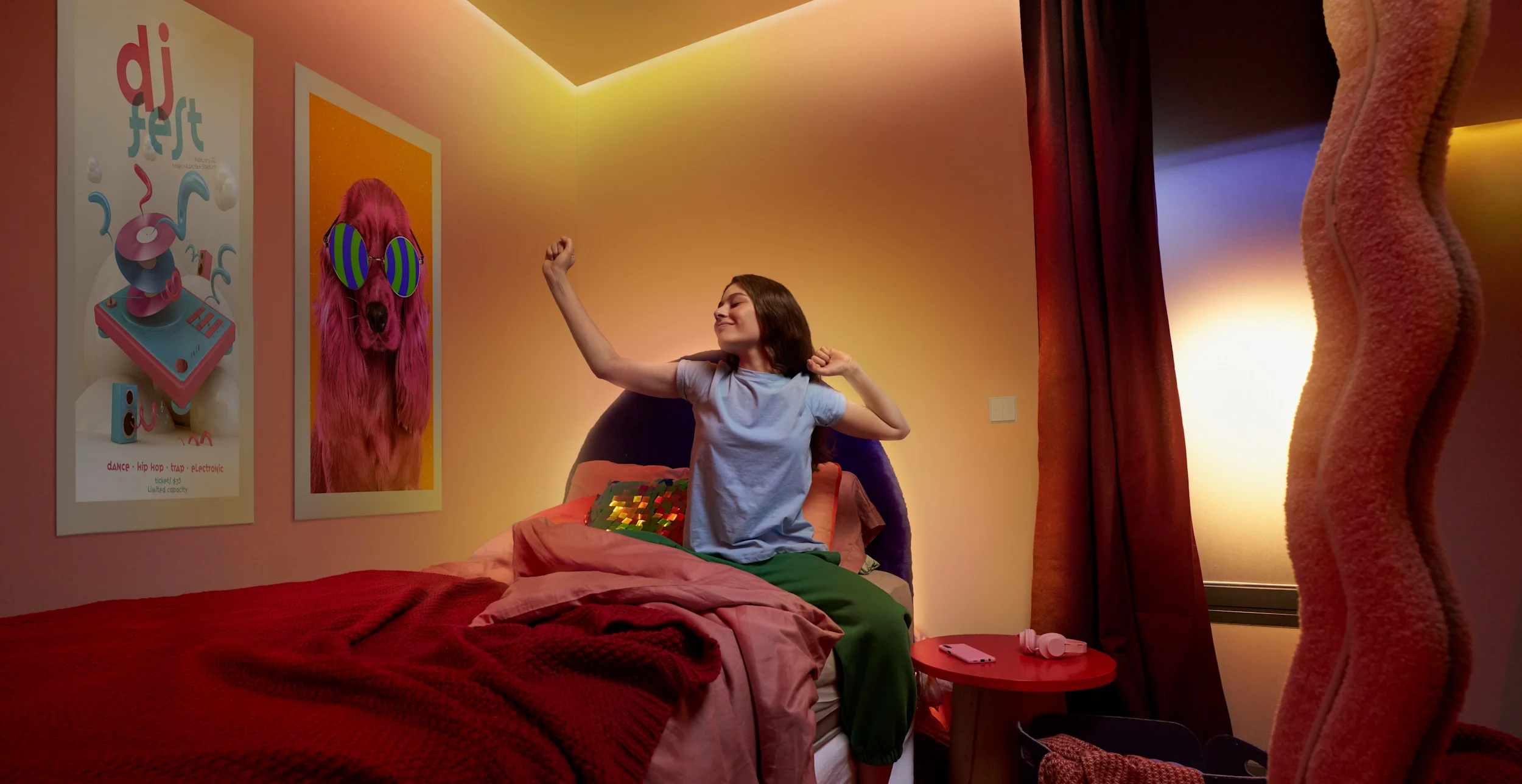 image of a woman waking up and stretching in her bedroom with ambient sunset WiZ lighting