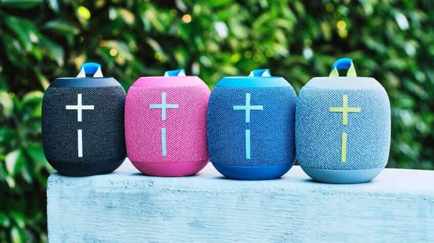 Image of four Ultimate Ears Wonderboom 4 Bluetooth Speakers next to each other in an outdoor setting