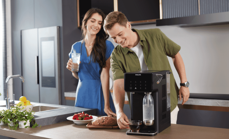 a man and a woman using the Philips water station 
