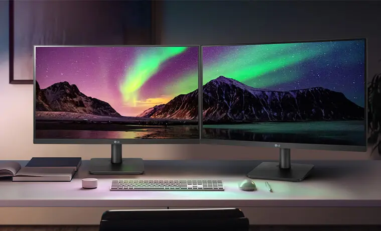 Two LG monitors stand sidebyside in a home study