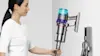 Woman docking her gen5detect absolute vac into the wall. 