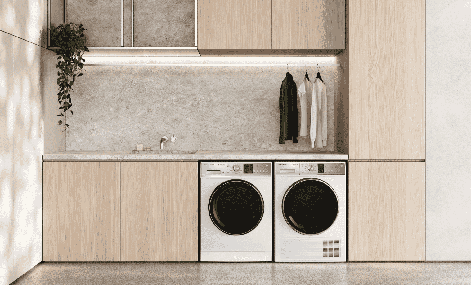 A matching washer and dryer in a light wood laundry