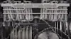 Cups in the top rack are being washed with a gentle cycle while dishes in the bottom rack are being washed at the same time on a strong cycle in an LG QuadWash dishwasher.