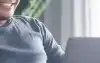 Father using a laptop at home on the couch