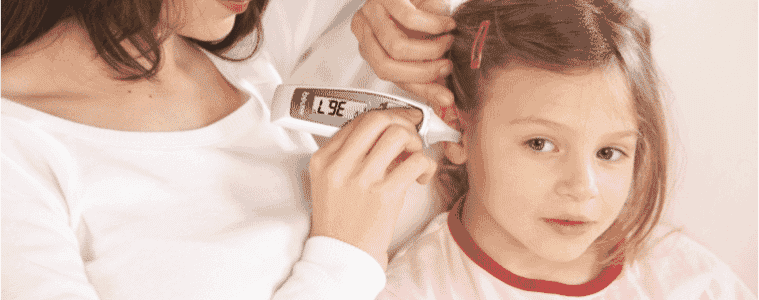 A mother checks her young daughters temperature using the Beurer MultiFunction Digital Thermometer