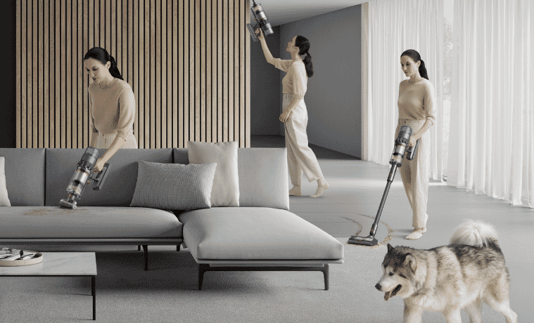 3 versions of the same woman walk around a living room using the different modes of a Dyson stick vacuum