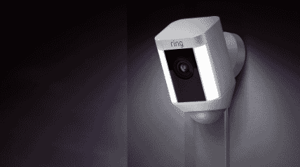 Ring Spotlight security camera sitting outside with motion lights on