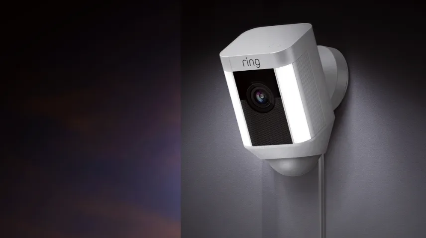 Ring Spotlight security camera sitting outside with motion lights on