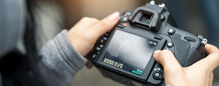 Closeup of a woman holding a digital camera up to take a photo