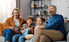 a mother father son and daughter watching an Easter movie at home 