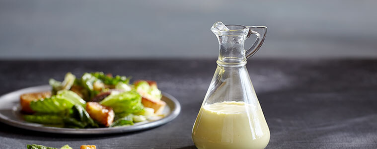 image of a Caesar salad dressing next to a Caesar salad 