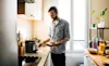 Man prepares coffee at home using a capsule coffee machine