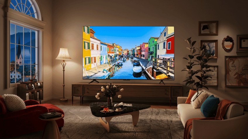 A scene with a bike plays on a TCL QLED TV in a white modern living room