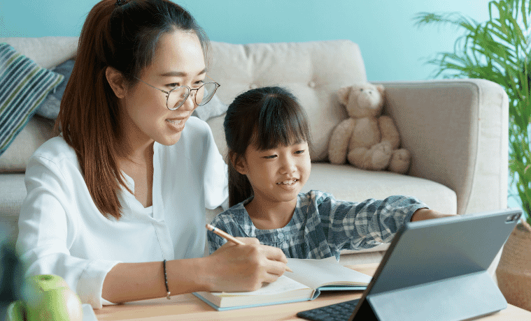 Mother and daughter using a 2in1 laptop together